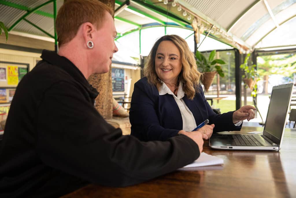Karen from Right Click using her laptop to explain bookkeeping to her client